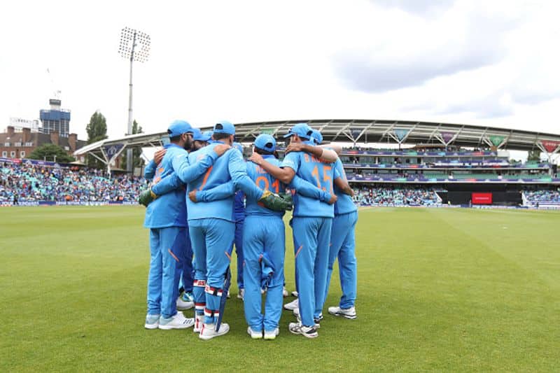 Indian players in a huddle before taking the field to bowl