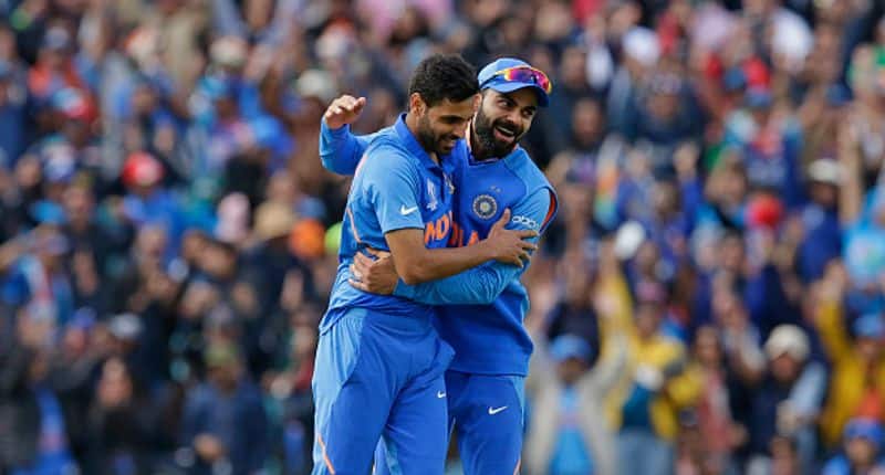 Bhuvneshwar Kumar is congratulated by Kohli after he took a wicket. He finished with figures of 350