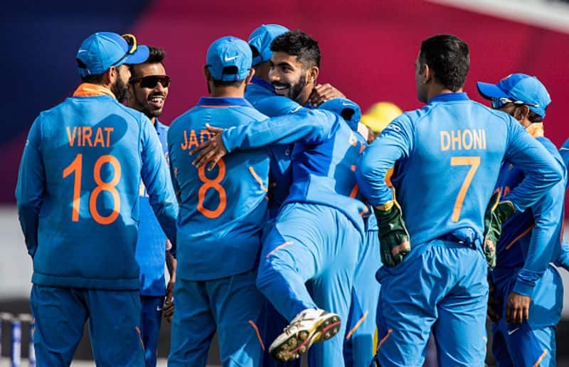 Bumrah is congratulated by his teammates after taking a wicket