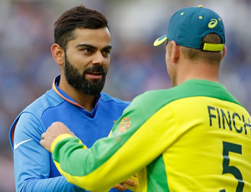 Kohli is congratulated by Australia captain Aaron Finch