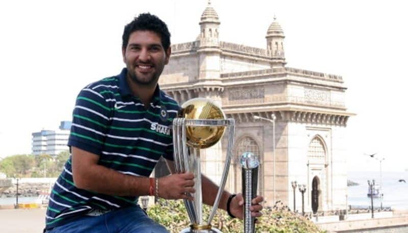 Yuvraj poses with the 2011 World Cup trophy and also his Man-of-the-tournament trophy