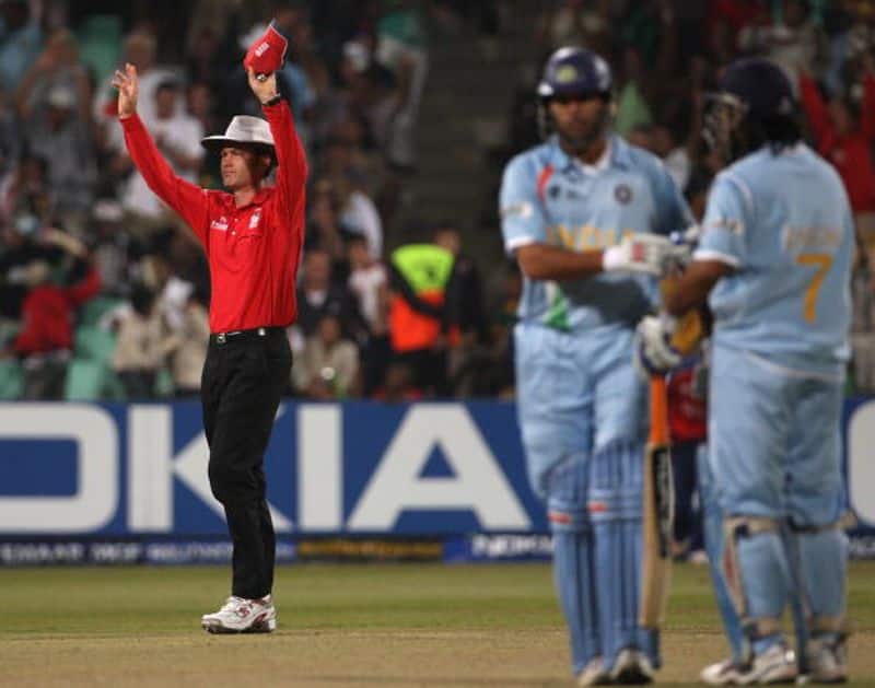 Australian umpire Simon Taufel signals a six as Yuvraj and Dhoni are seen on the pitch. This was one of the six sixes signalled by Taufel in that record match in Durban. Yuvraj hit six sixes in an over of Broad