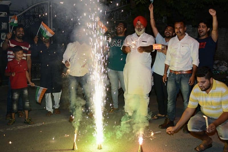 Cricket fans in Amritsar celebrate after India defeated Pakistan in Manchester