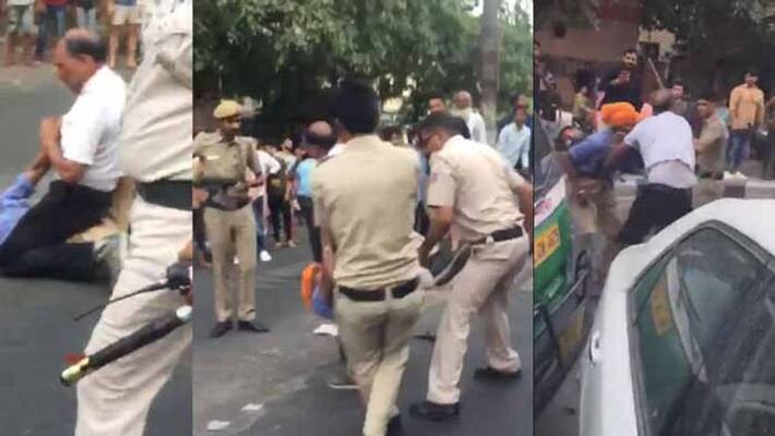 auto driver and his son beaten, dragged and kicked on road in delhi auto driver and his son beaten, dragged and kicked on road in delhi