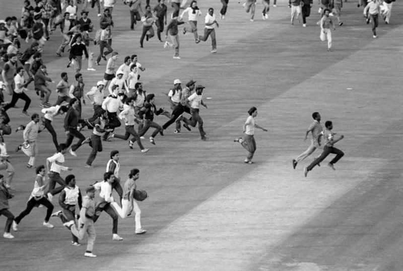 Fans invade the pitch after India's victory in the final