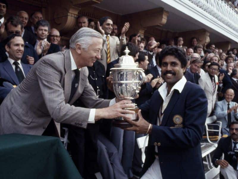 Kapil receives the Prudential World Cup Trophy from the Chairman of Prudential Assurance, Lord Carr of Hadley