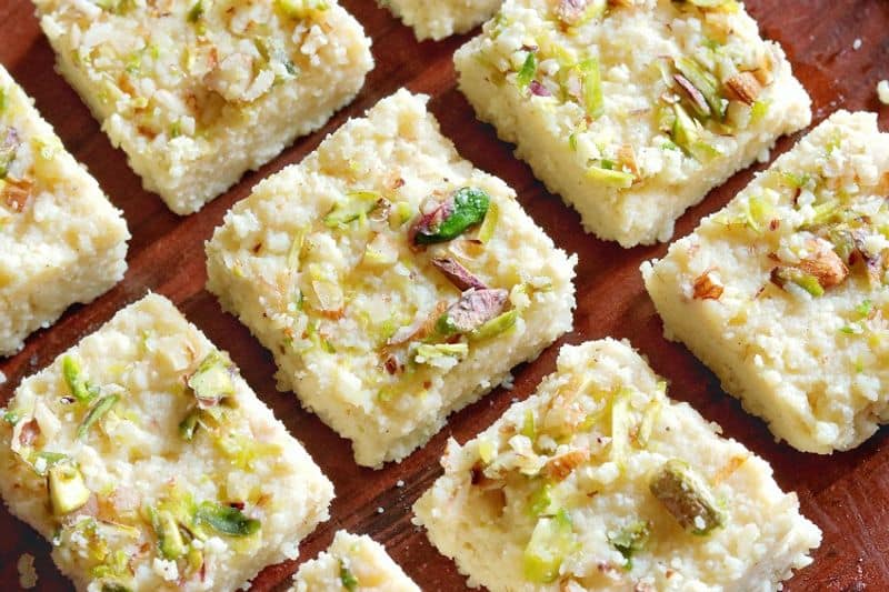 Kalakand is made with full cream milk, sugar and dry fruits.  In this recipe milk heated  and thickened. Then sugar and dry fruits are added to it. Later it will be cut into small square pieces.