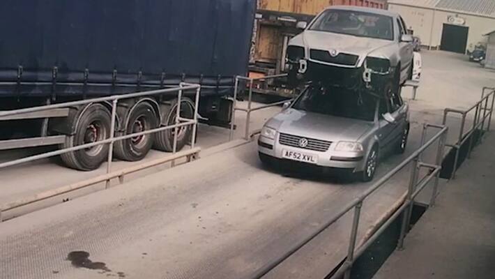 Photo of man driving car on top of car goes viral Photo of man driving car on top of car goes viral