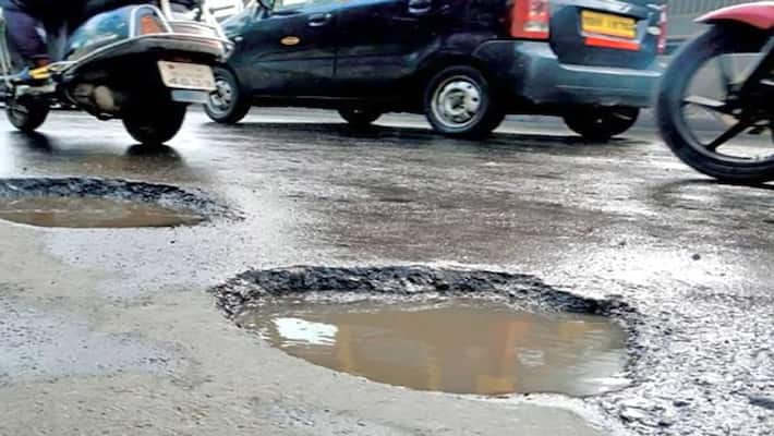 Potholes on the road from rain and construction work in bengaluru rav Potholes on the road from rain and construction work in bengaluru rav