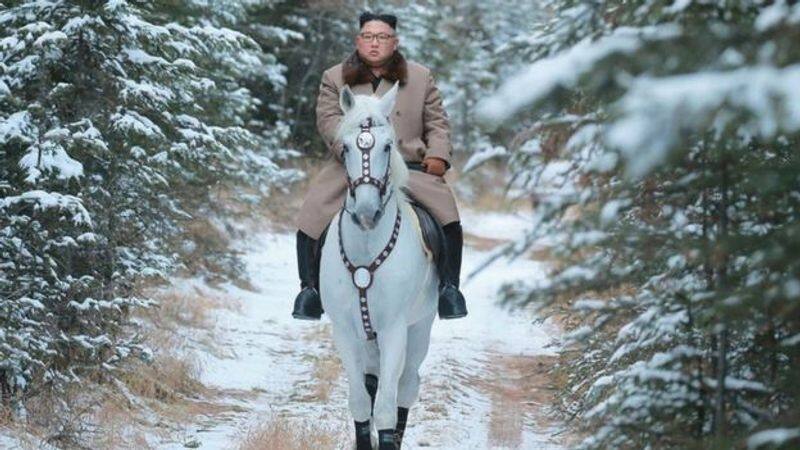 North Korean Kim jong un  leader rides horse up sacred mountain
