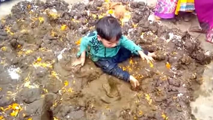 parents throwing their children in the dung to celebrate this Puja parents throwing their children in the dung to celebrate this Puja