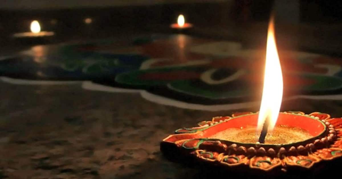 lighting diya for diwali