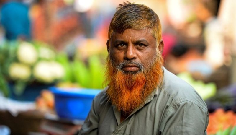 reason why bangladeshi men are dyeing their beards orange