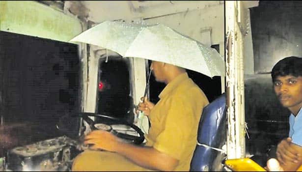 bus driver used umbrella while driving as it rained and leaked inside the bus