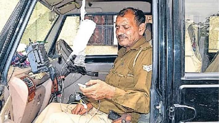 policeman kept doing duty by put drip bottel in his hand policeman kept doing duty by put drip bottel in his hand