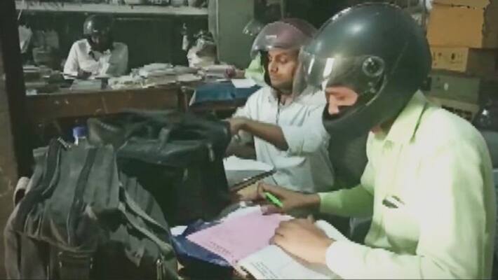 Employees of electricity dept wear helmets while working Employees of electricity dept wear helmets while working