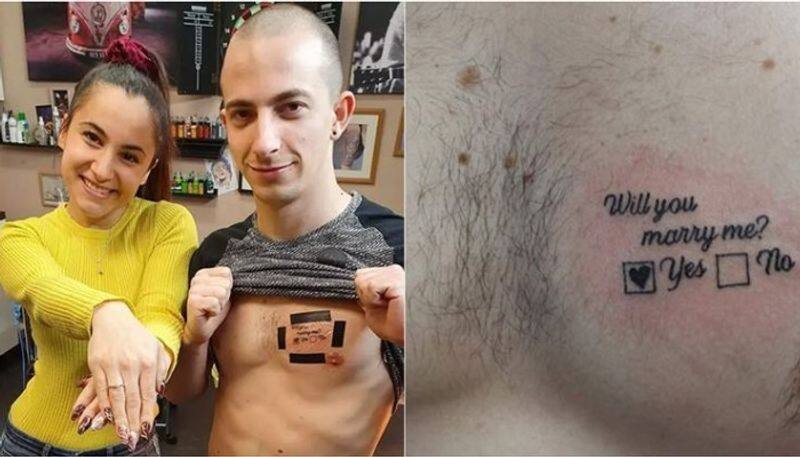 Man proposes woman with tattoo on chest