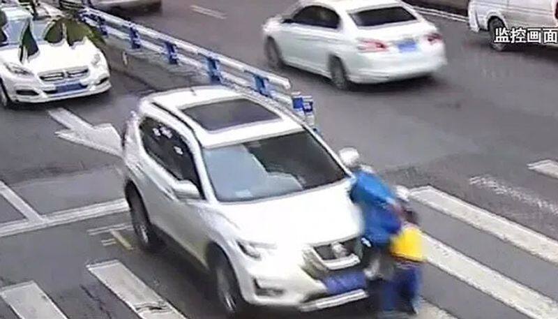 little boy kicks car and tells off driver after he knocks down mother on zebra crossing