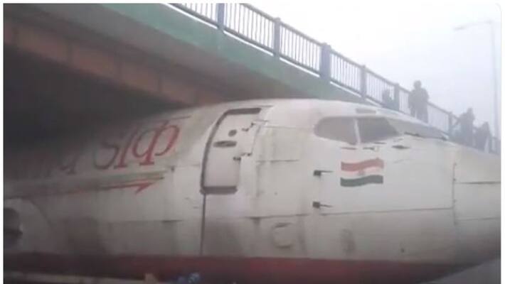 truck with abandoned aircraft stuck under bridge truck with abandoned aircraft stuck under bridge