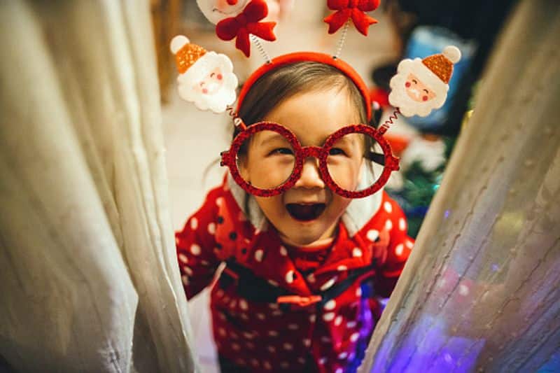 When the toddler wears Santa Claus eyeglasses, headband and smiles joyfully at the camera, your worries fade away