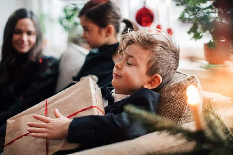 Unwrapping Christmas presents while sitting with family is always heartwarming