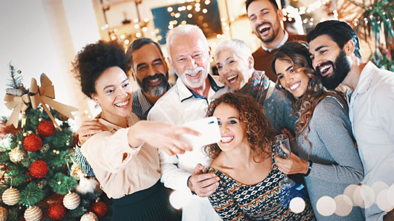 Multi-generation family celebrating Christmas at home gets captured with the selfie click