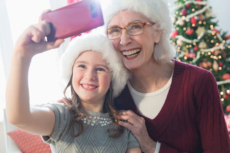 Caucasian grandmother and granddaughter take that perfect selfie making it a Christmas special