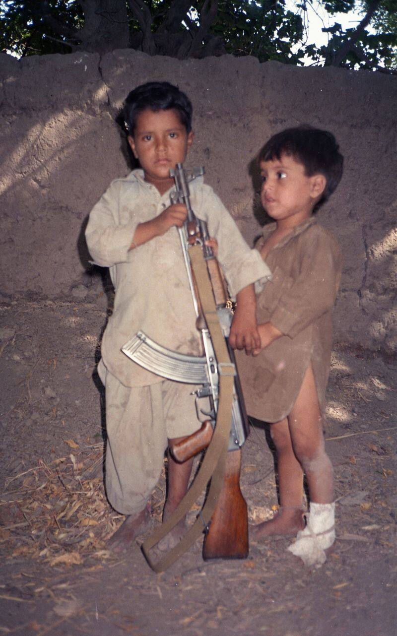 Afghan village where children come to school with AK 47 Assault rifles