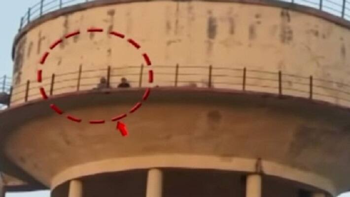 A woman climbed on a water tank A woman climbed on a water tank