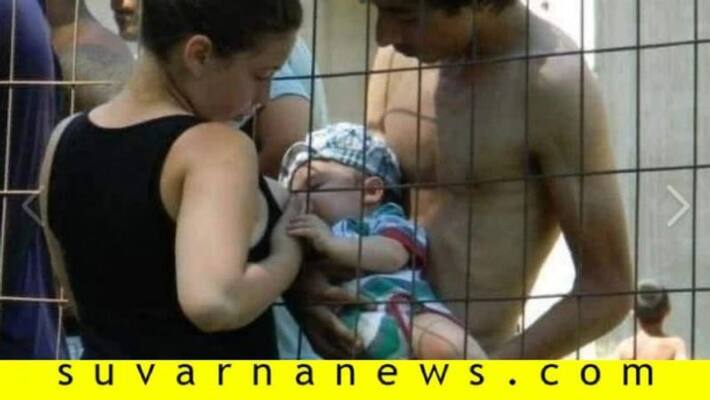 Fact Check Pic of woman breastfeeding baby across fence is not from detention camp in India Fact Check Pic of woman breastfeeding baby across fence is not from detention camp in India