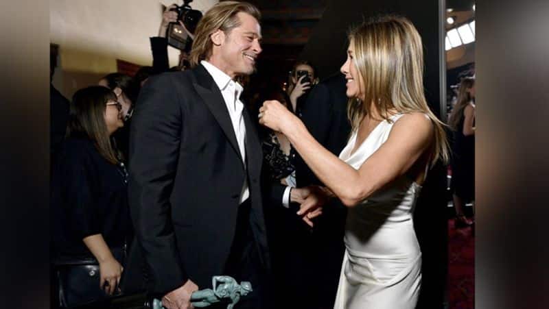 Brad Pitt and Jennifer Aniston giggling backstage