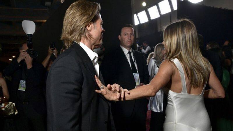 Brad Pitt and Jennifer Aniston giggling backstage