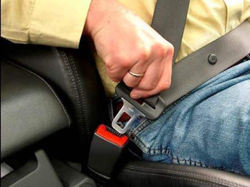 Is it required to use a seat belt when riding in the back seat?