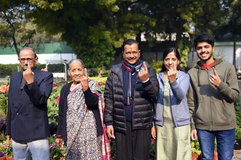 Delhi Chief Minister Arvind Kejriwal along with family show ink-marked finger after casting vote in the Delhi Legislative Assembly elections in New Delhi on Saturday.