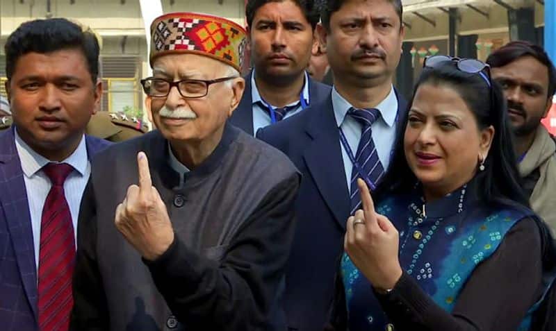 Senior Bharatiya Janata Party leader LK Advani and his daughter Pratibha Advani show their ink marked finger after casting vote at a polling booth during the Delhi Legislative Assembly elections, at Aurangzeb lane, in New Delhi on Saturday.