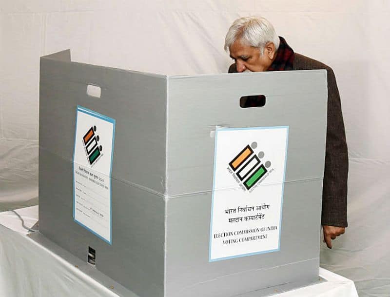 Chief Election Commissioner Sunil Arora casting vote, at a polling booth, during the Delhi Assembly Election, at Nirman Bhawan, in New Delhi on Saturday.