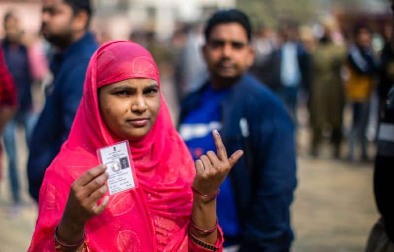 An Indian Muslim woman shows her indelible ink marked finger outside a polling station, after casting her vote on February 8, 2020 in Shaheen Bagh area of Delhi.