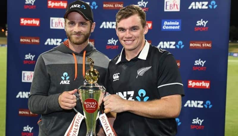 Kane Williamson and Tom Latham pose with the winners trophy