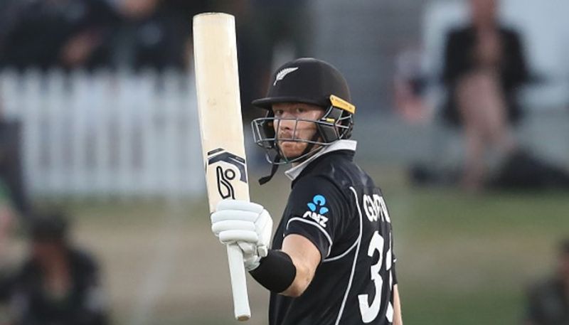 Martin Guptill celebrates his half century