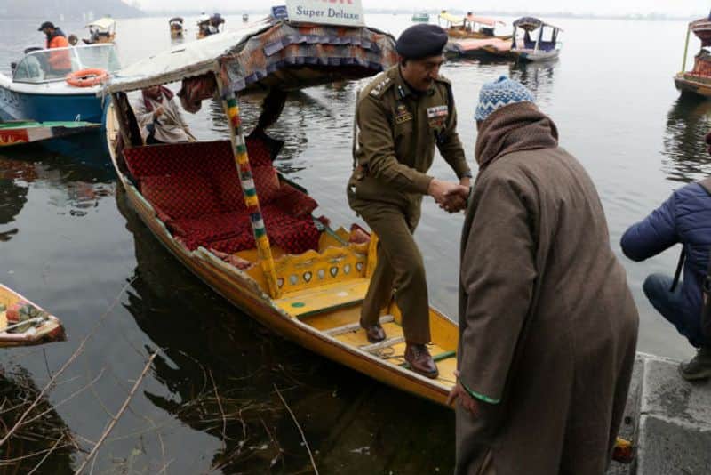 A J&K top cop at the Dal Lake, along with a fresh batch of foreign envoys in Srinagar. (Photograph: Adil AbassBarcroft Media via Getty Images)