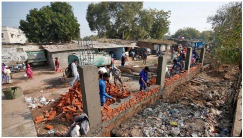 Ahmedabad builds a big  wall to keep slums out of US President Trump sight