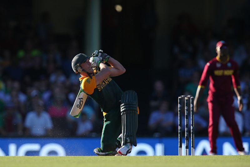 Down on one knee, AB de Villiers sends the ball soaring into the stands