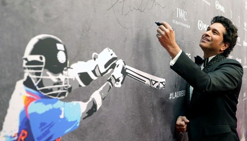 Indian batting legend Sachin Tendulkar signs the wall as he arrives to attend Laureus World Sports Awards 2020 ceremony in Berlin on February 17
