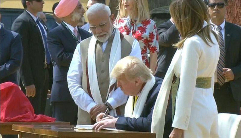 Trump signs in visitors book at Sabarmati ashram