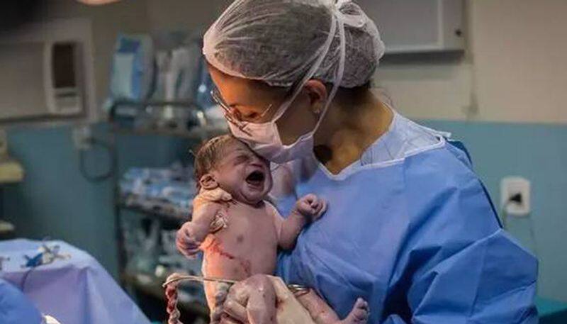 Picture of newborn looking angrily at doctor becomes viral meme