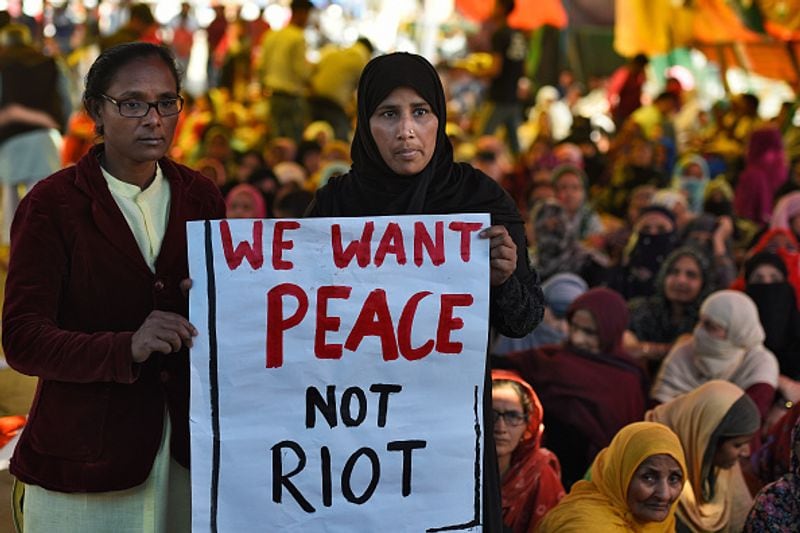 women in front of against national citizenship amendment bill photo story