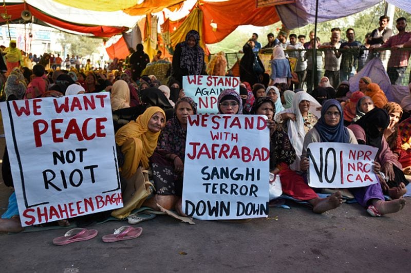 women in front of against national citizenship amendment bill photo story