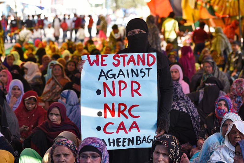 women in front of against national citizenship amendment bill photo story