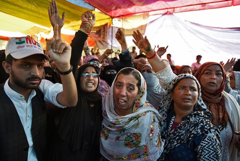 women in front of against national citizenship amendment bill photo story