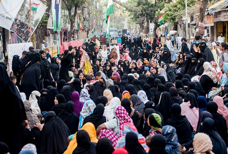 women in front of against national citizenship amendment bill photo story